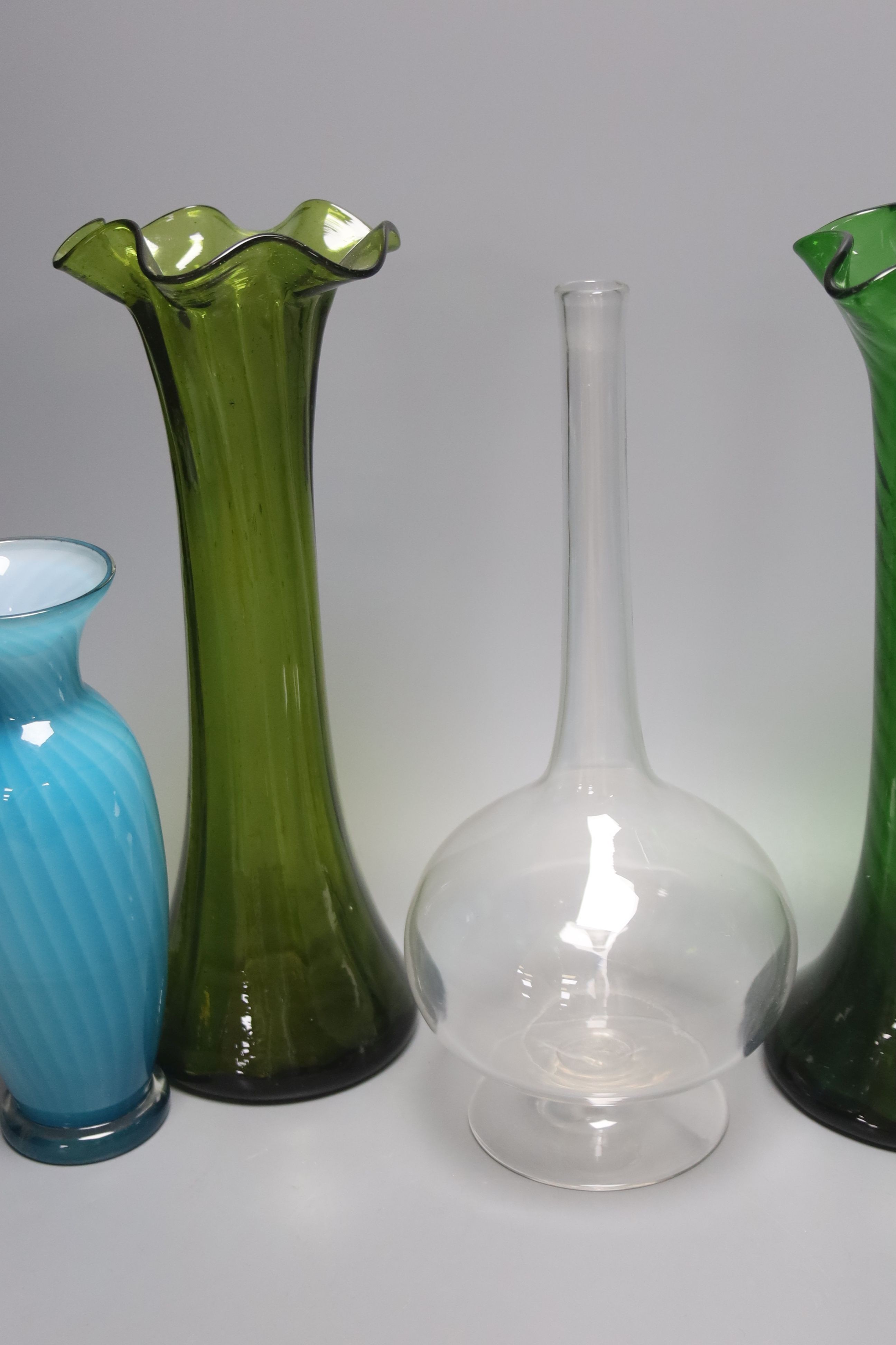 Two green glass hyacinth vases, a carafe and two other vases 30.5cm